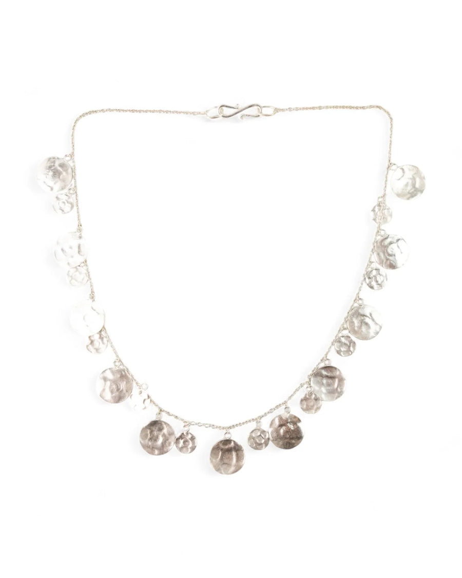 Hammered round silver disc necklace with handcrafted organic textures on a delicate chain
