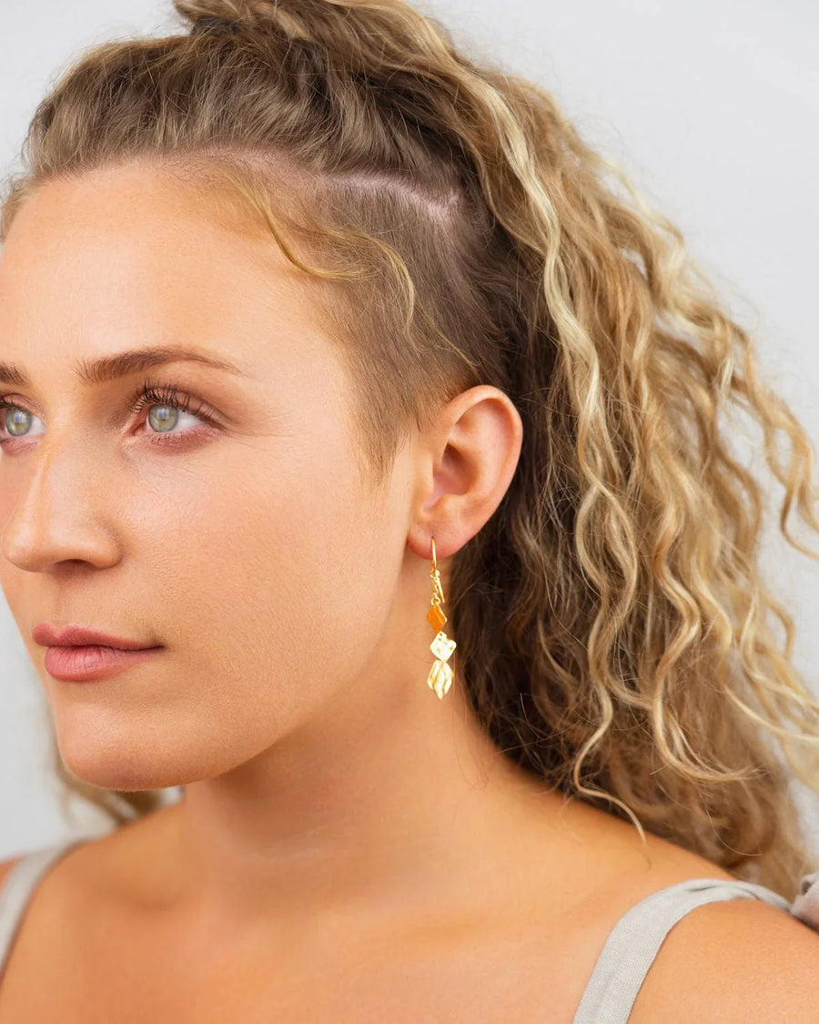 Gold hammered square dangly earrings with amber and clear gemstones.
