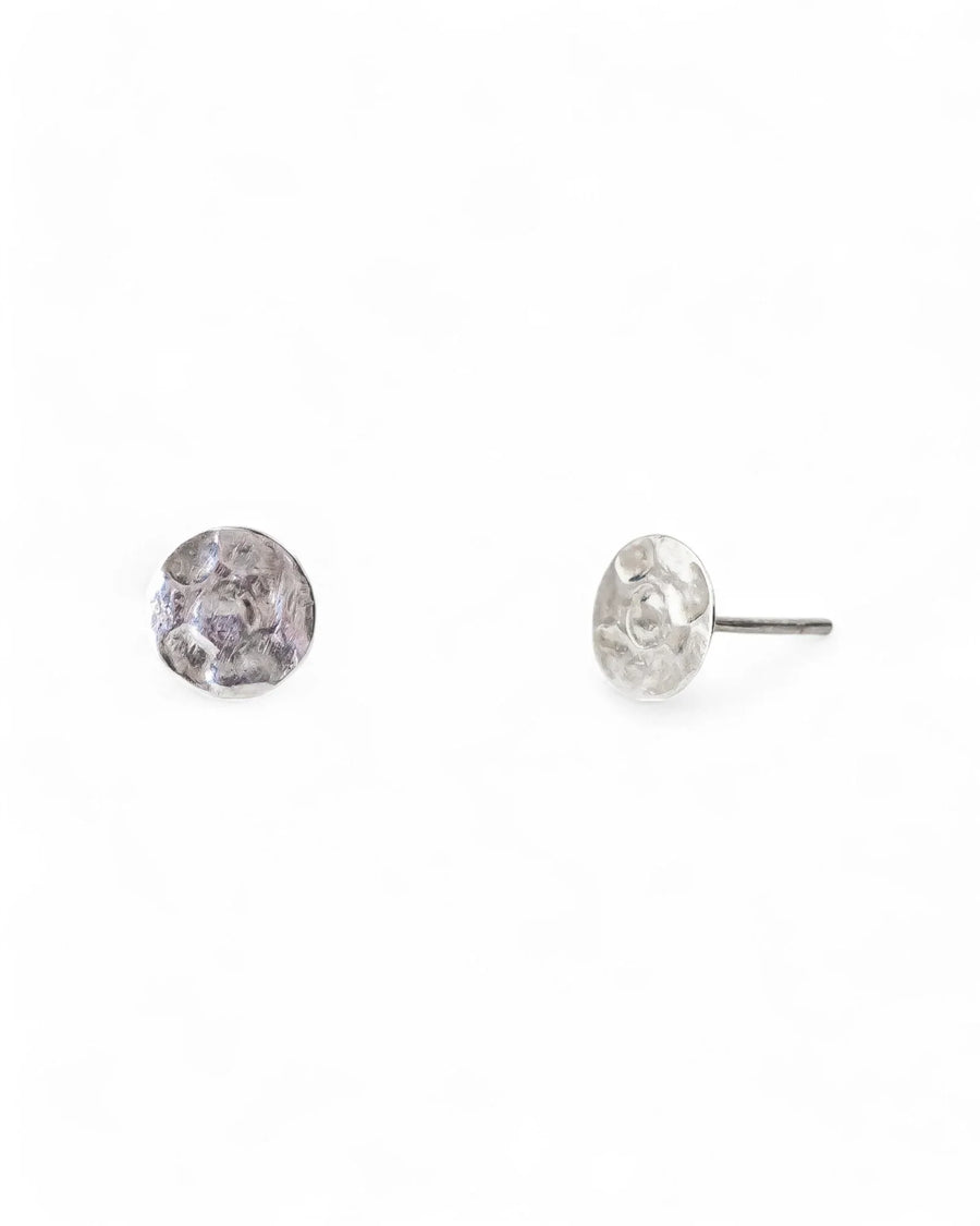 Silver hammered stud earrings with a textured, organic shape.