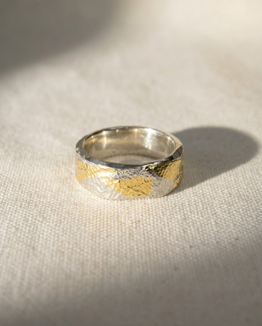6mm flat ring in 9ct white and yellow gold with a textured, hammered finish on a neutral fabric background.