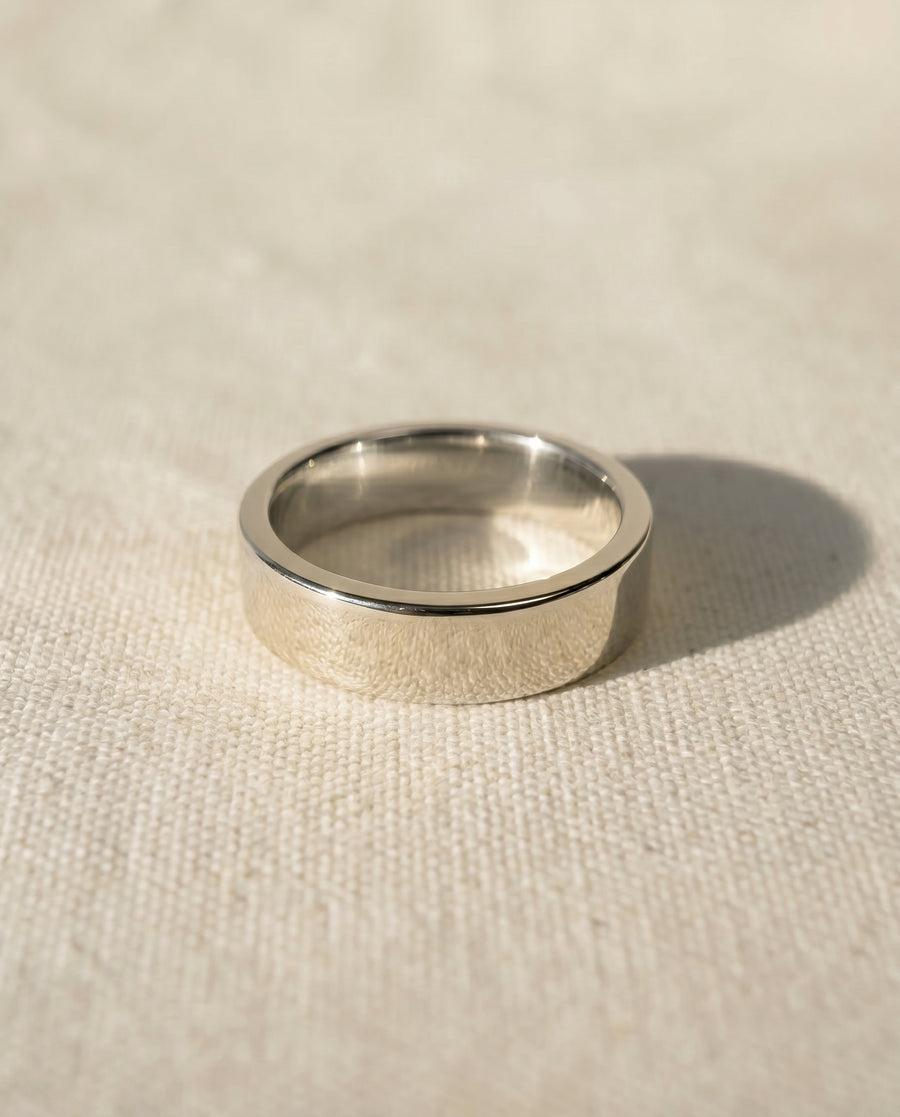 Polished 9ct white gold flat wedding ring, 4mm wide.
