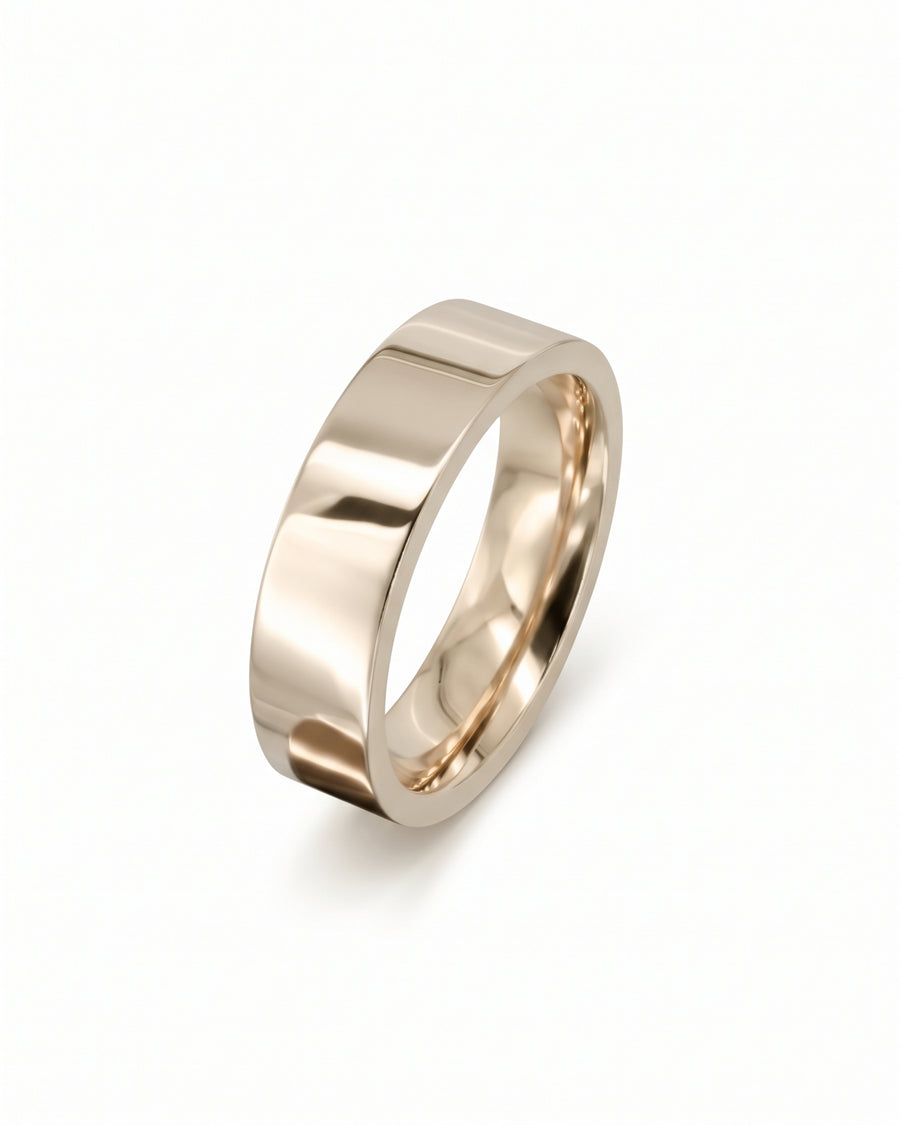 Polished yellow gold flat wedding ring with a smooth, minimalist band design.