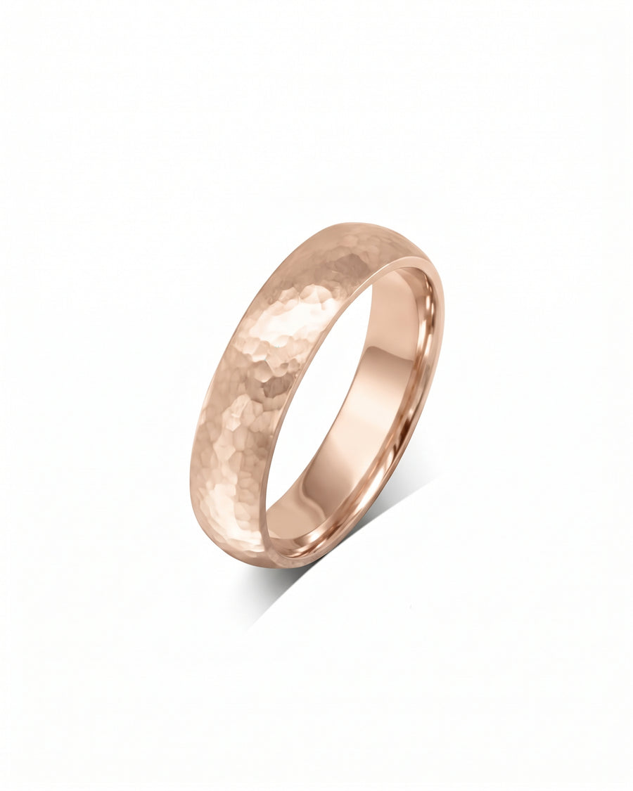 4mm 9ct rose gold court wedding ring with a matte hammered finish.