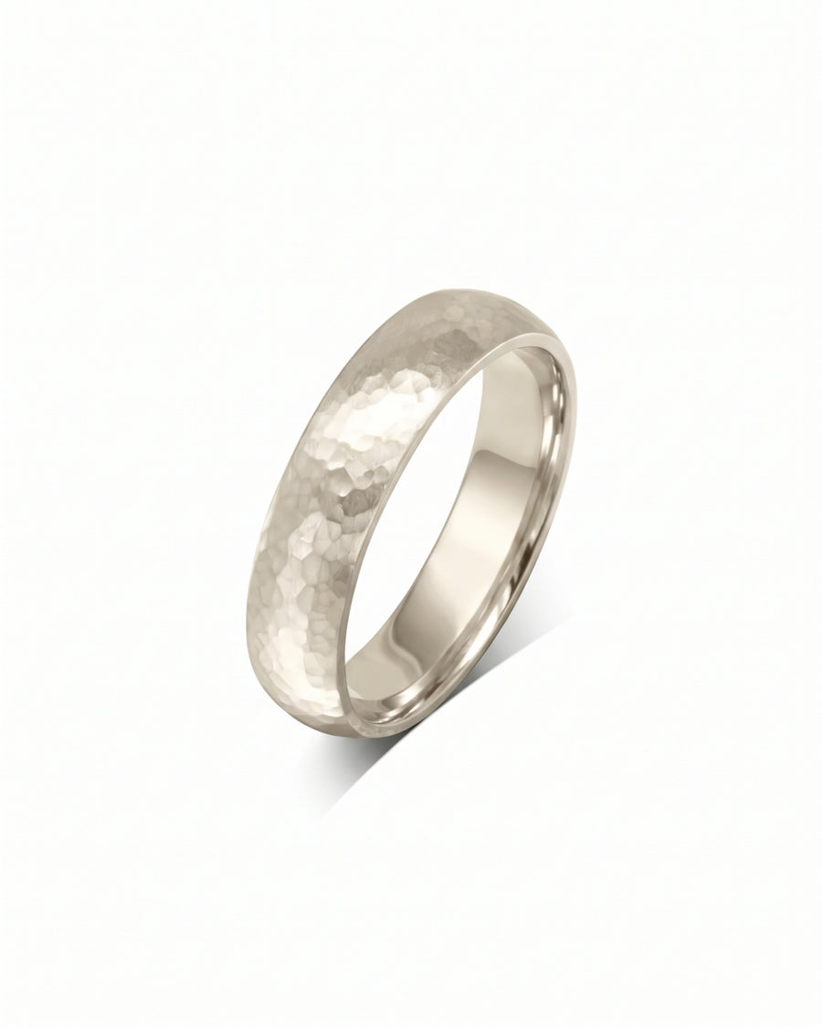 4mm 9ct white gold court wedding ring with a textured hammered finish.