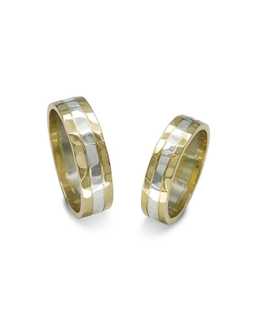 Hammered two tone wedding rings with yellow gold and silver bands on white background