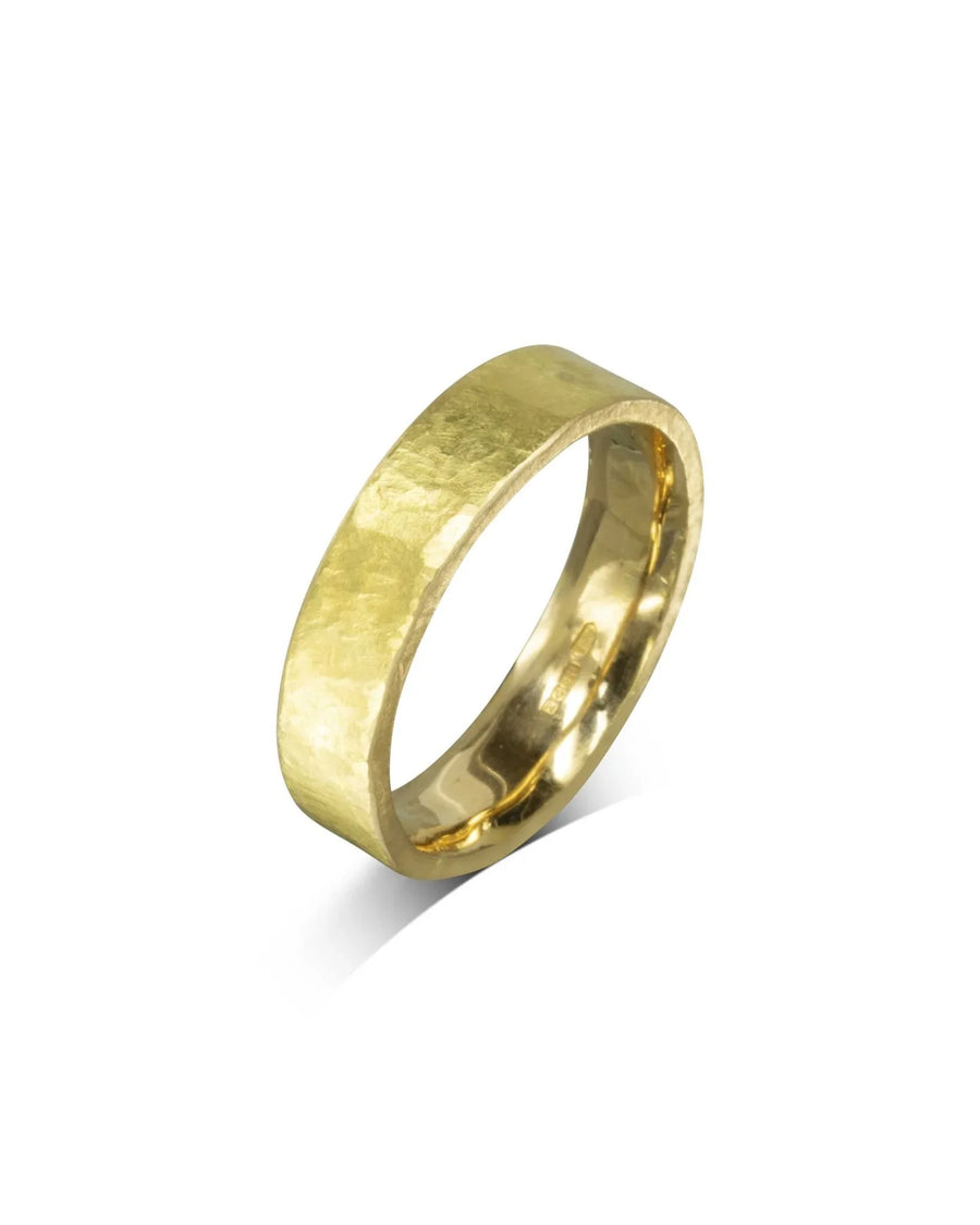 Men's rough hammered yellow gold wedding ring.
