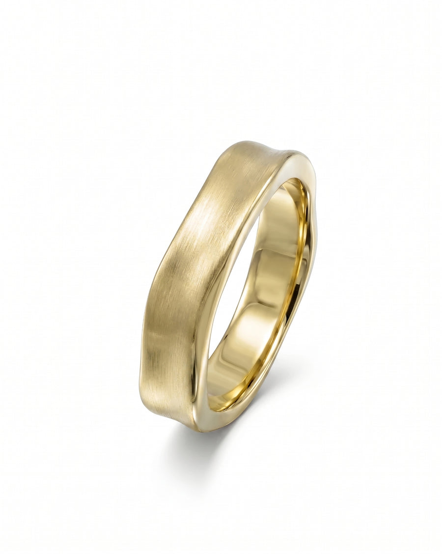 Gold men's wedding ring with a side hammered, brushed finish.