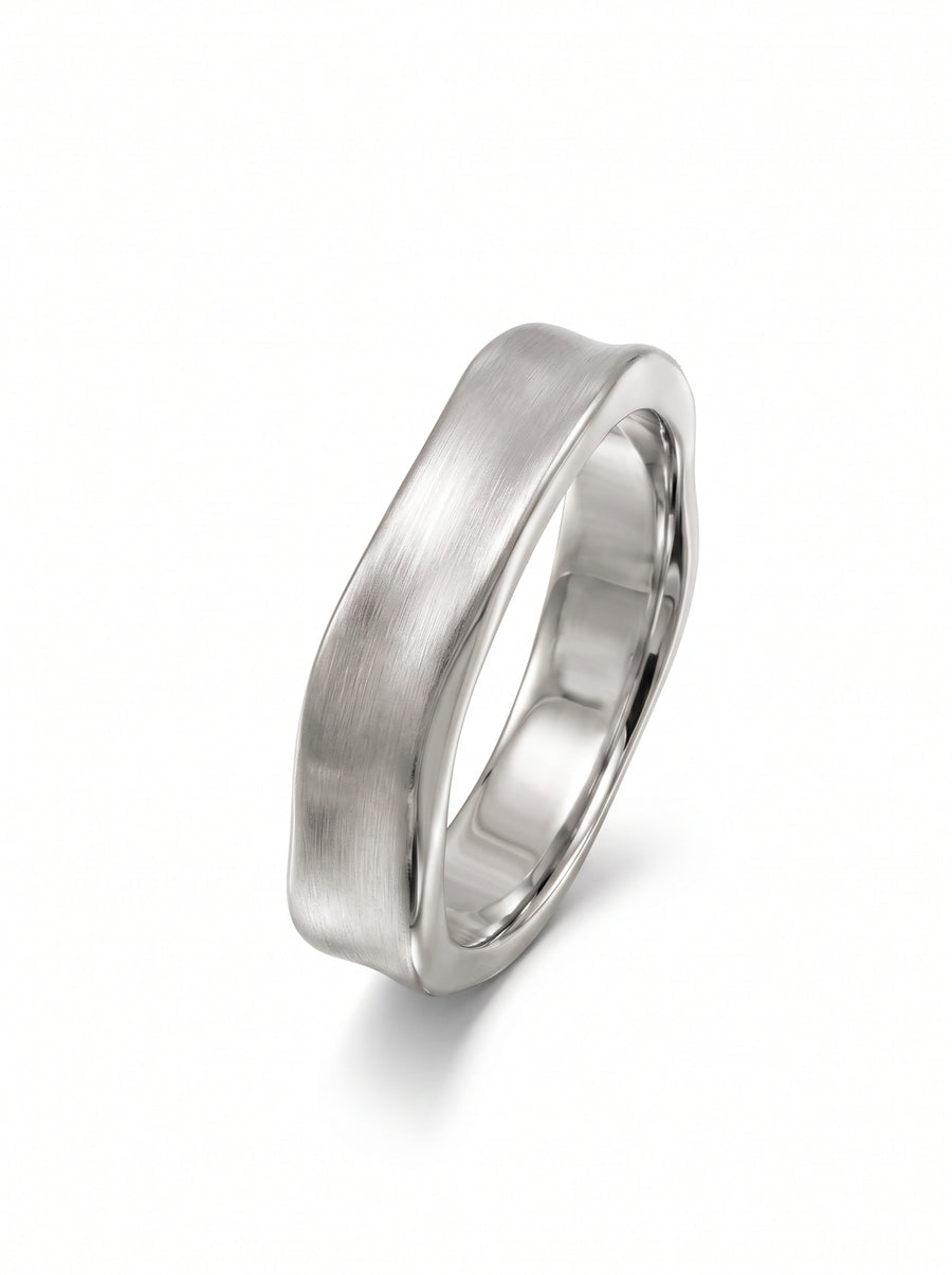 Silver-toned metal wedding ring with a brushed finish and a unique hammered side design.