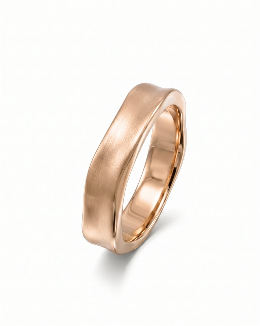 Rose gold wedding ring with a brushed finish and hammered side detailing on a white background.