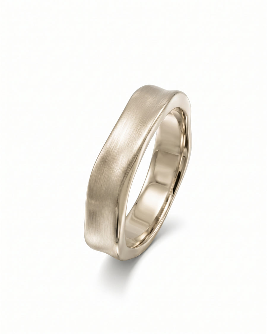 Men's brushed gold wedding ring with a hammered side finish and a smooth polished interior.
