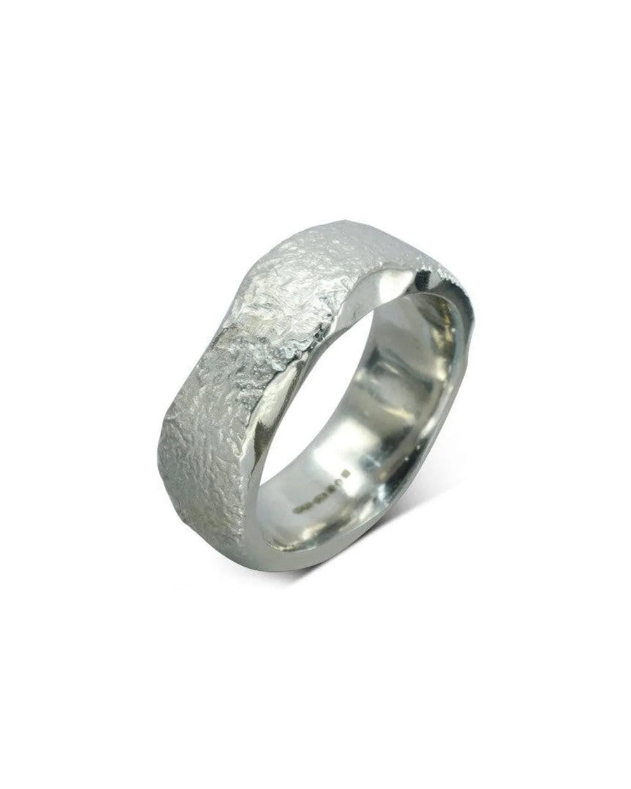 Handmade platinum wedding ring with hammered texture and organic shape on white background