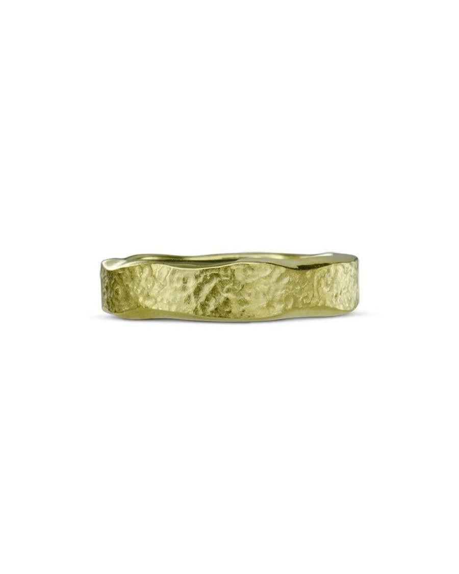 Yellow gold wedding ring with hammered textured finish and organic edge on white background