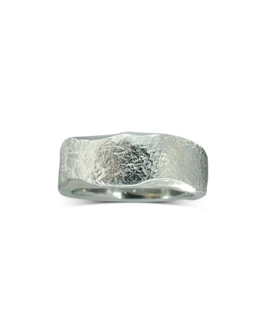 Hammered textured platinum wedding ring with organic, rugged finish on white background