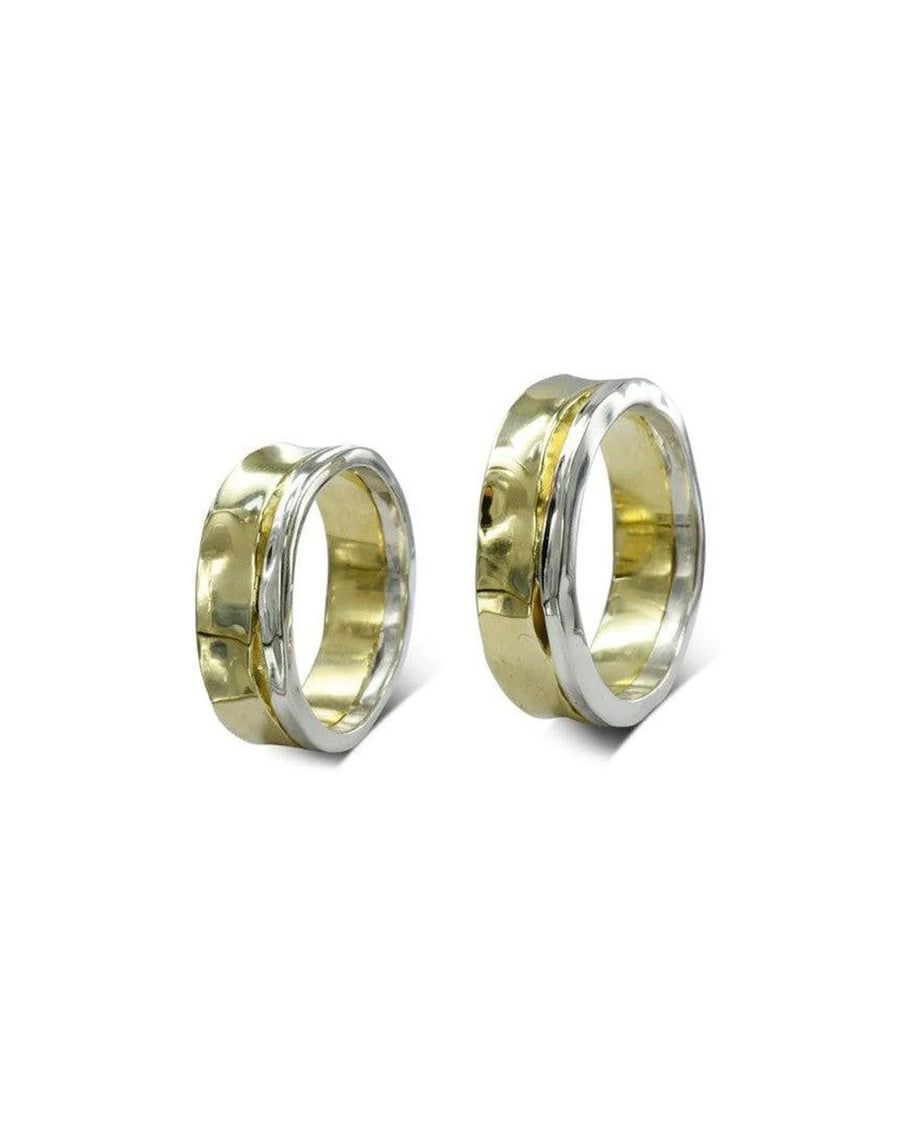 Pair of hammered two-tone gold wedding rings with organic, textured finish