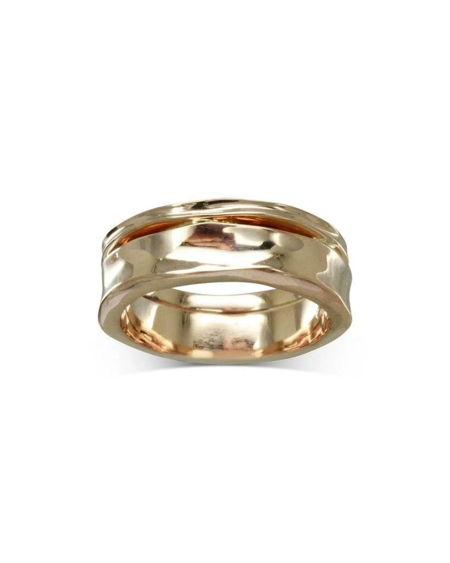 7mm hammered gold wedding ring with organic, textured finish on white background