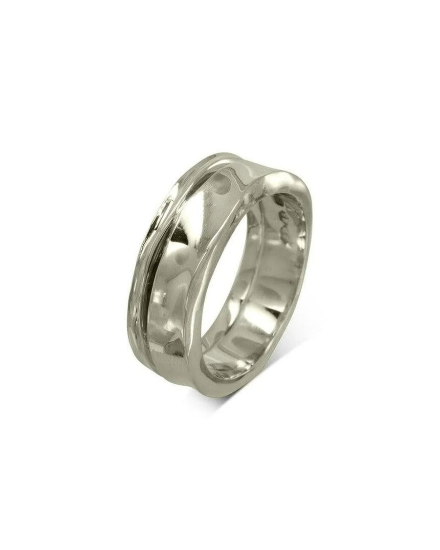 Handmade hammered gold wedding ring with organic, textured finish on white background