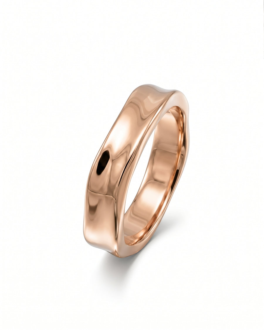 Rose gold men's wedding ring with a polished, wavy hammered side design on a white background.