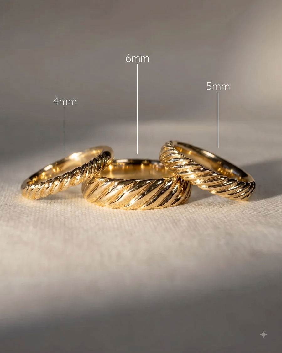 Three yellow gold twisted wedding bands in 4mm, 5mm, and 6mm widths arranged on a textured surface.