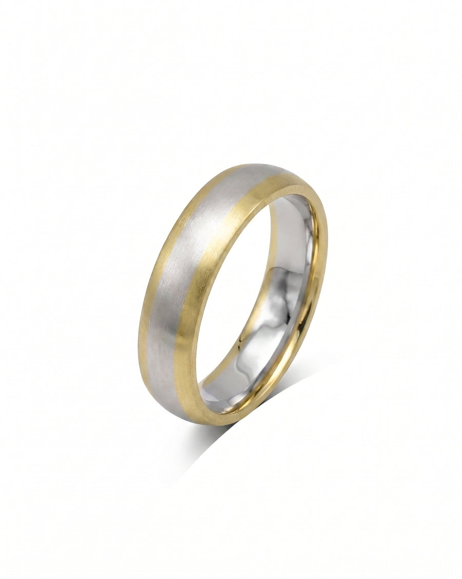 Mixed metal court shaped wedding band with a brushed silver center and polished gold edges.