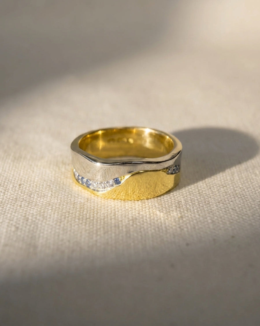 Platinum and 18ct yellow gold eternity ring with diamonds and sapphires.