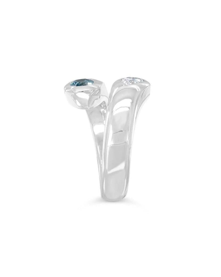 Platinum toi et moi ring with aquamarine and diamond gemstones on a white background