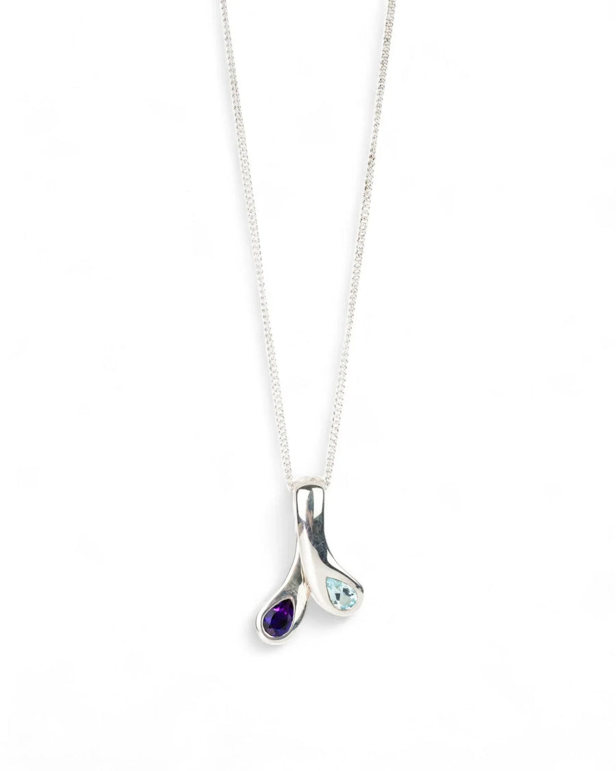 Silver pendant necklace with organic teardrop shapes, set with blue topaz and amethyst gemstones