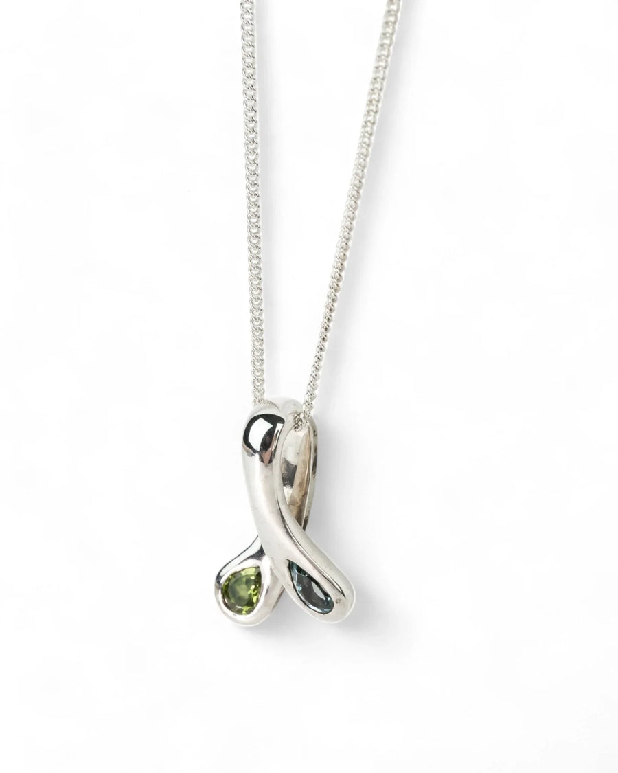 Sterling silver organic pendant with blue topaz and peridot gemstones on a chain necklace