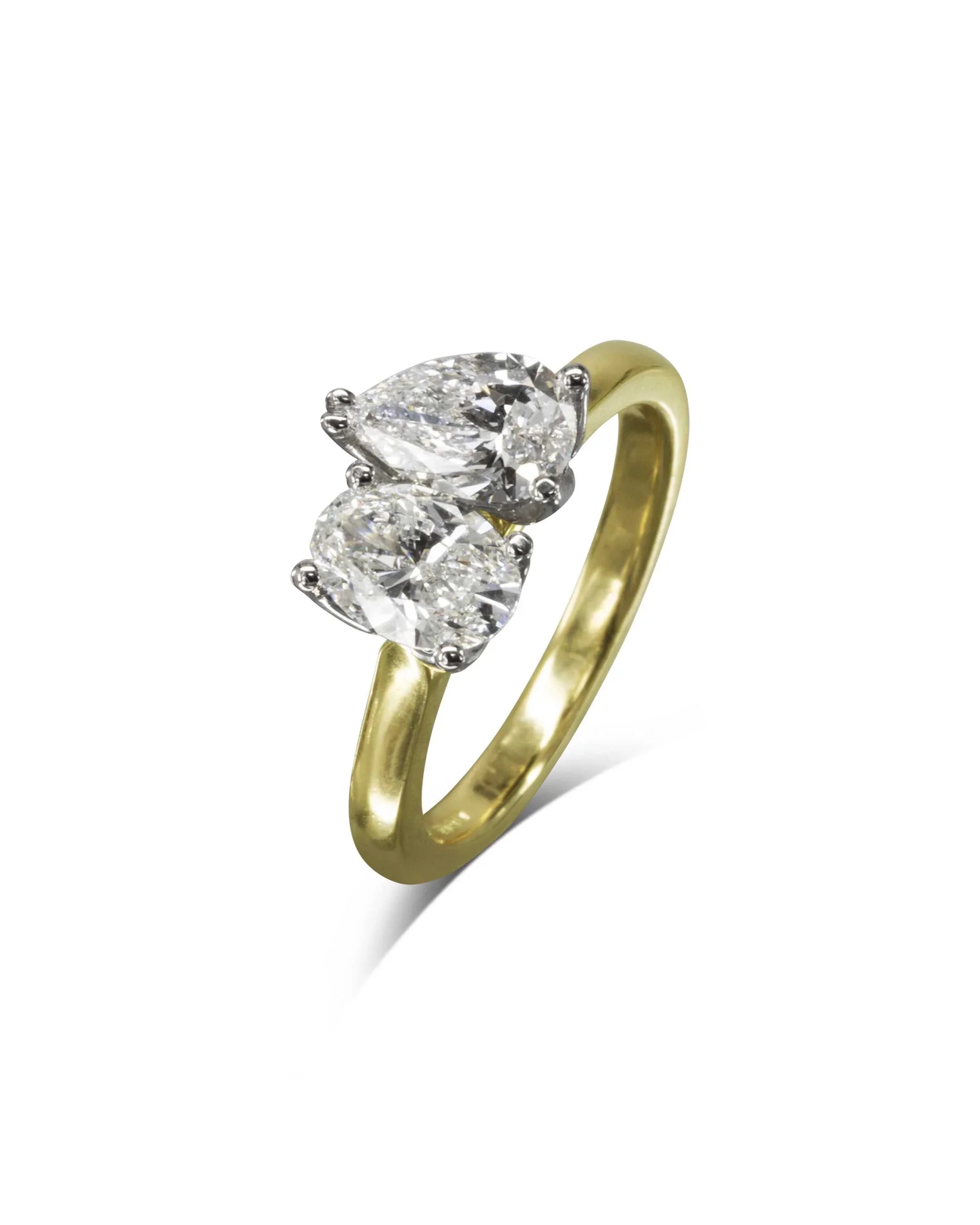Two stone diamond engagement ring with yellow gold band on white background
