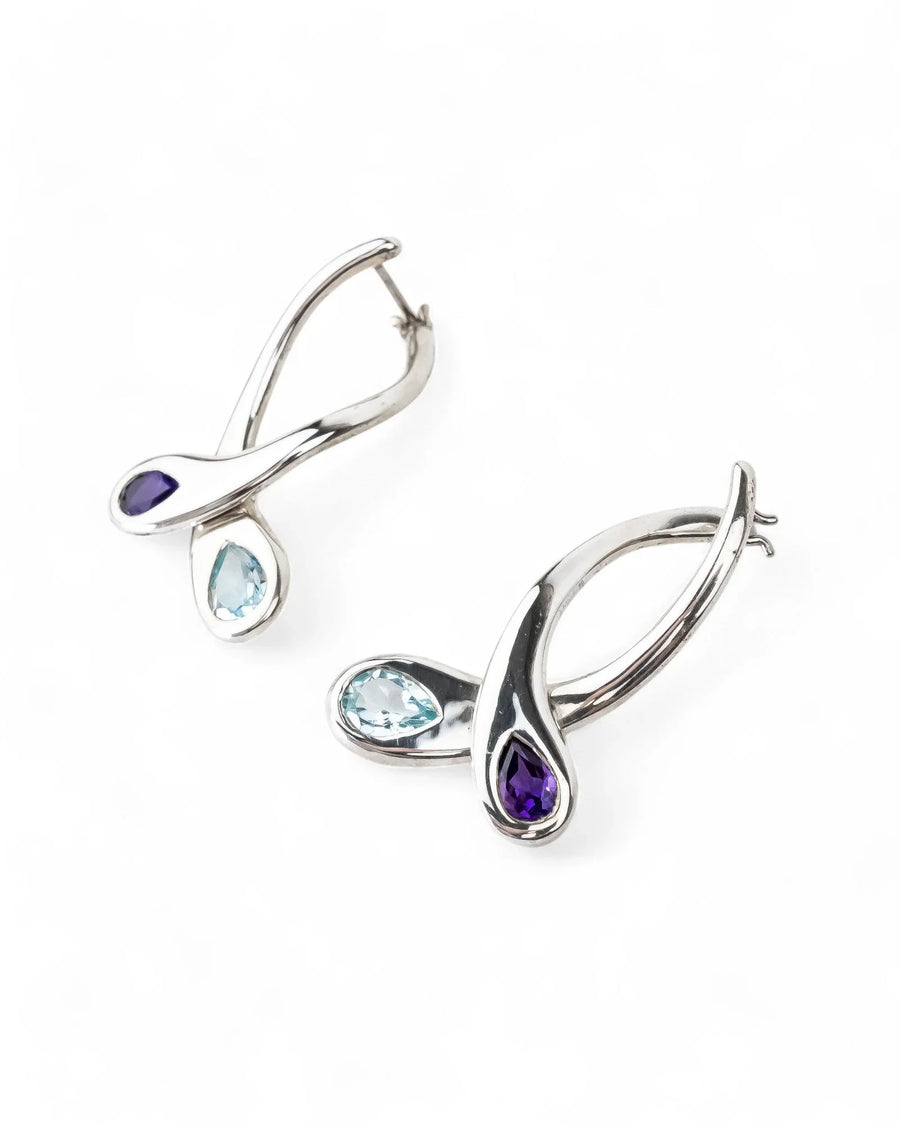 Silver drop earrings with teardrop amethyst and blue topaz gemstones on white background
