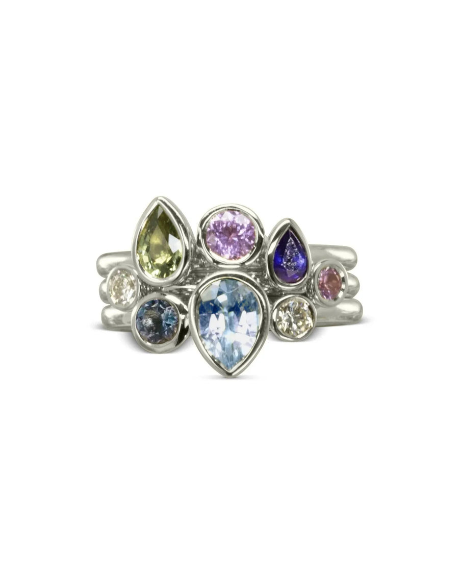 Silver stacking rings with multi-coloured aquamarine and sapphire pear and oval gemstones.