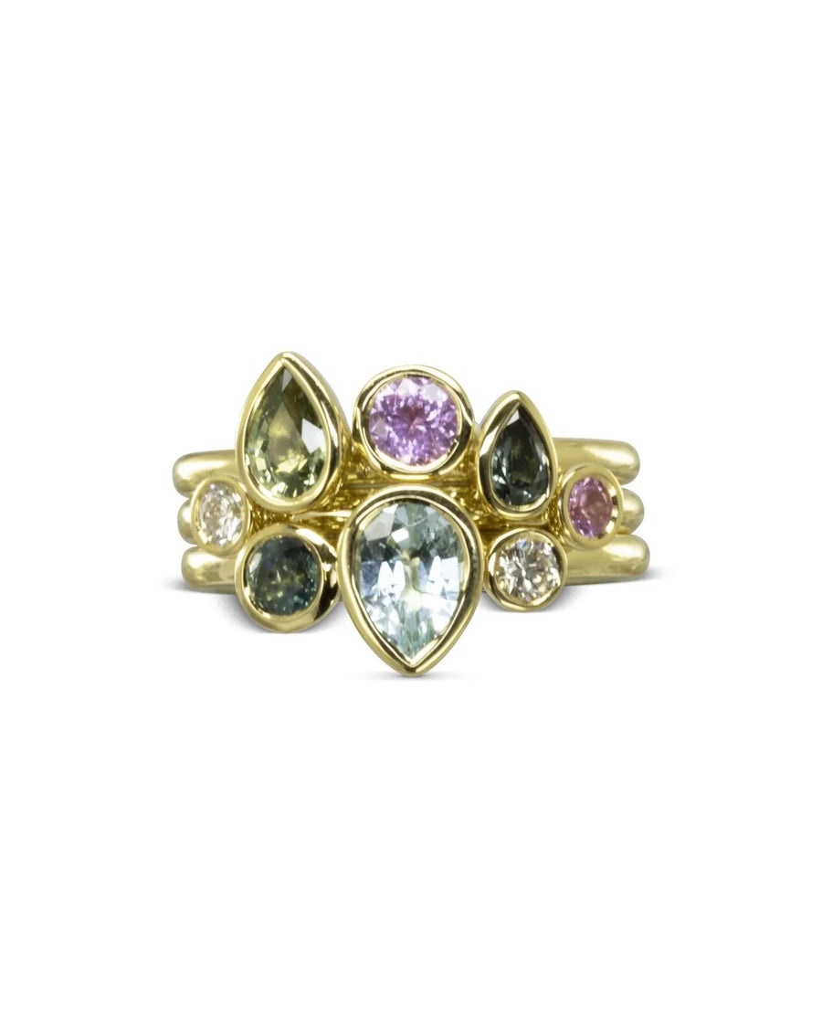 Gold stacking ring set with multi-coloured aquamarine and sapphire pear and oval gemstones.