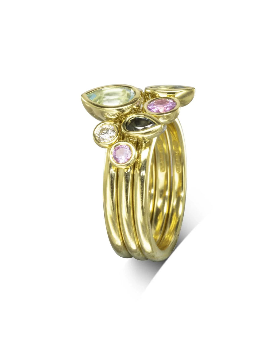 Gold stacking ring set with multi-coloured aquamarine and sapphire pear gemstones.