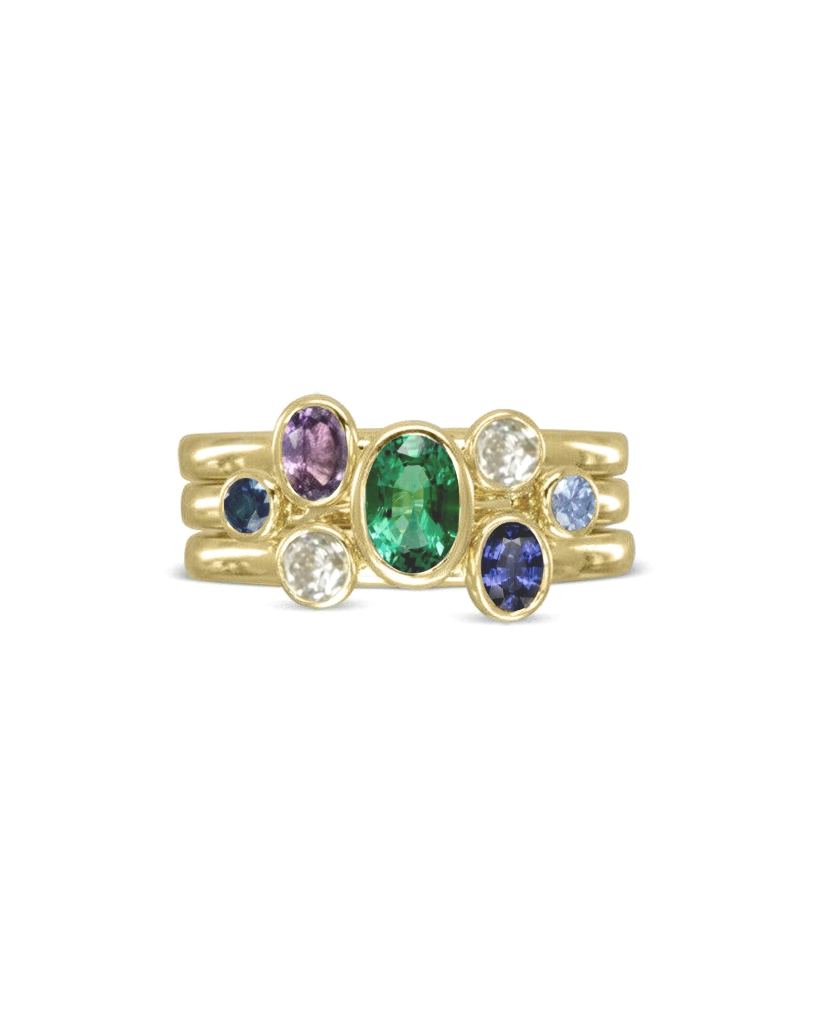Gold stacking ring set with multi-coloured oval sapphires and an emerald.