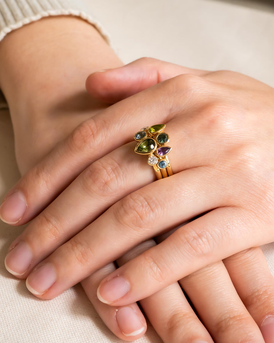 Gold stacking ring set with multi-coloured pear shaped sapphires.