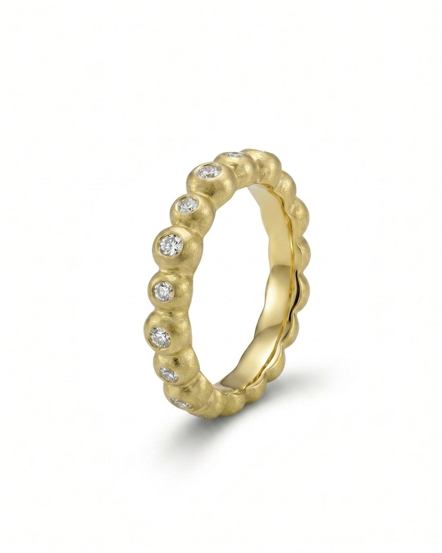 Nugget dainty yellow gold diamond eternity ring with round diamonds.