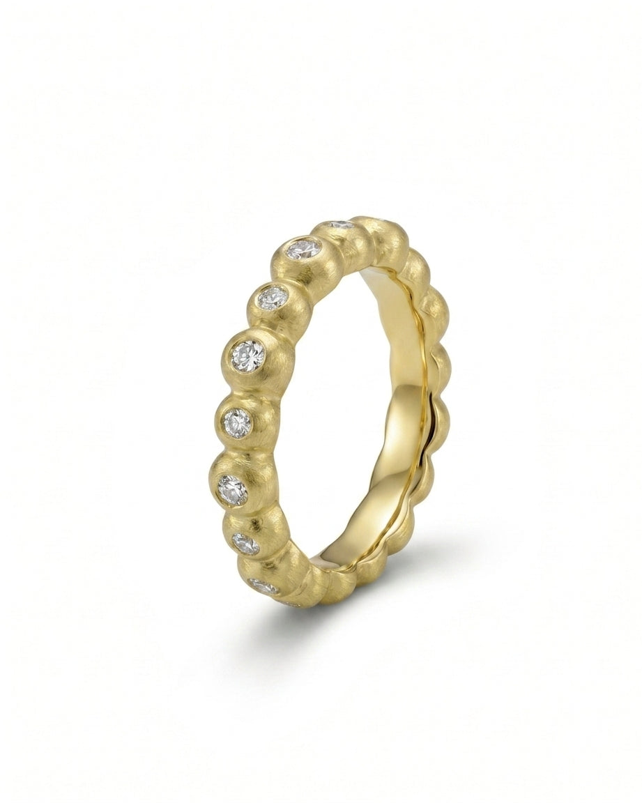 Nugget dainty yellow gold diamond eternity ring with round diamonds.