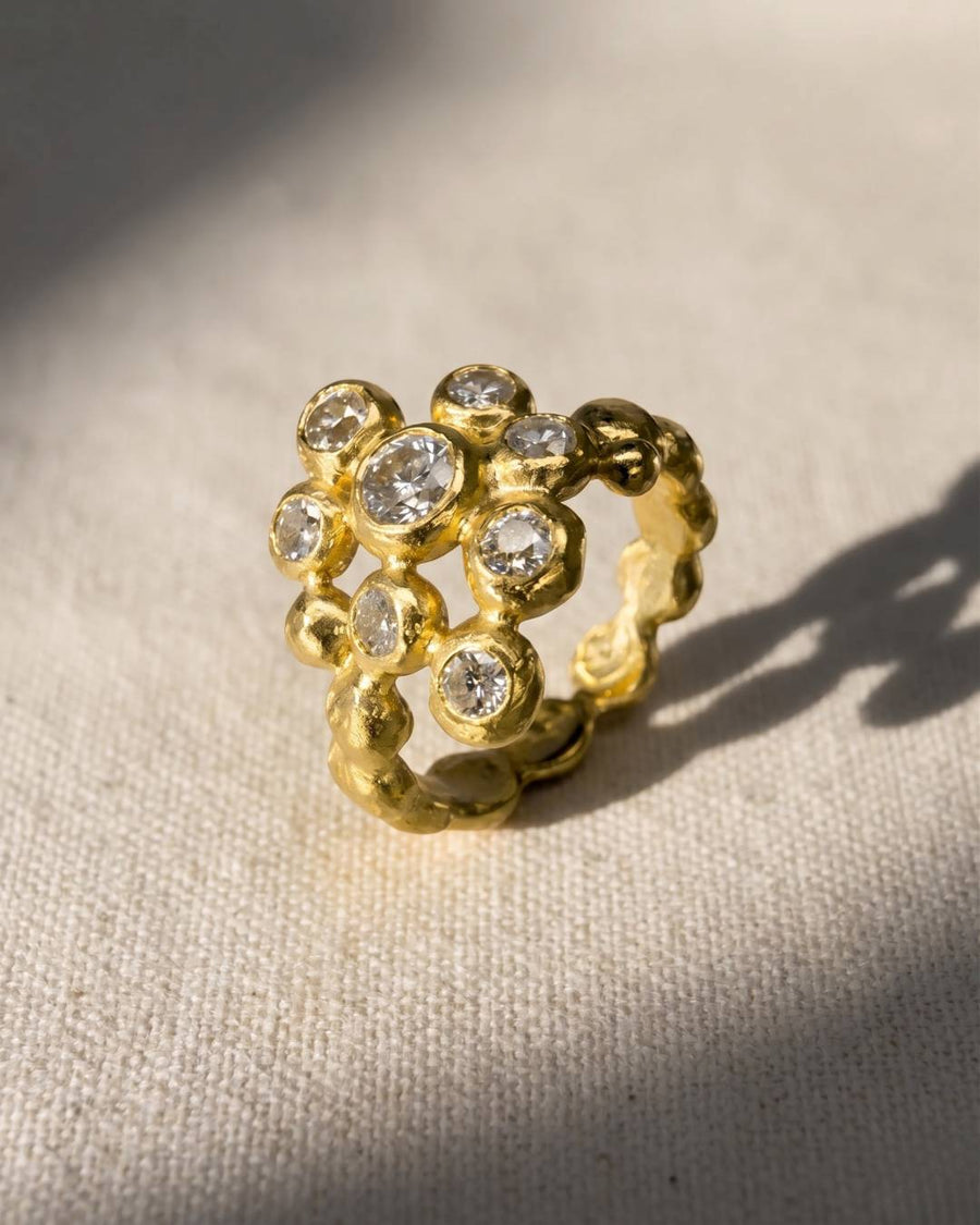 Gold nugget diamond cluster ring with multiple clear stones.