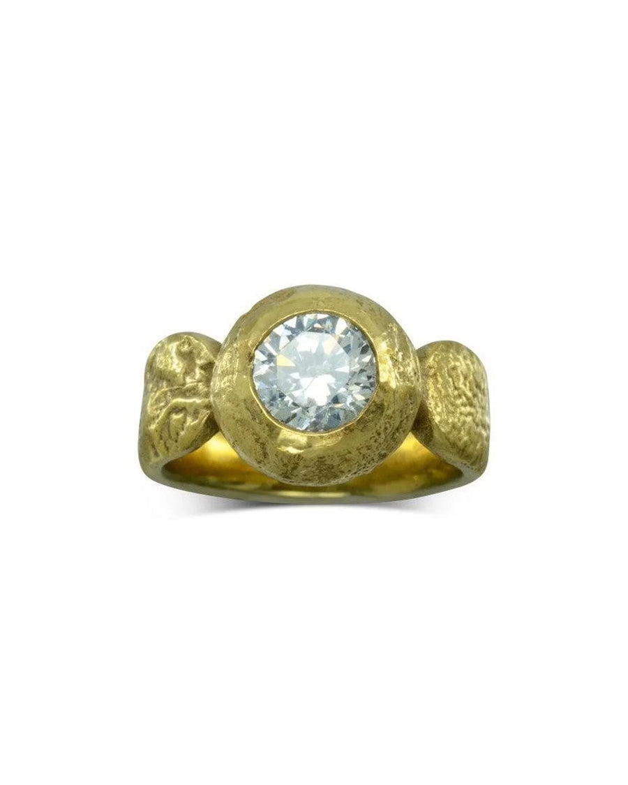 Gold nugget ring with a round, clear diamond.