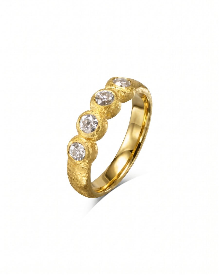 Gold nugget ring with four round diamonds.