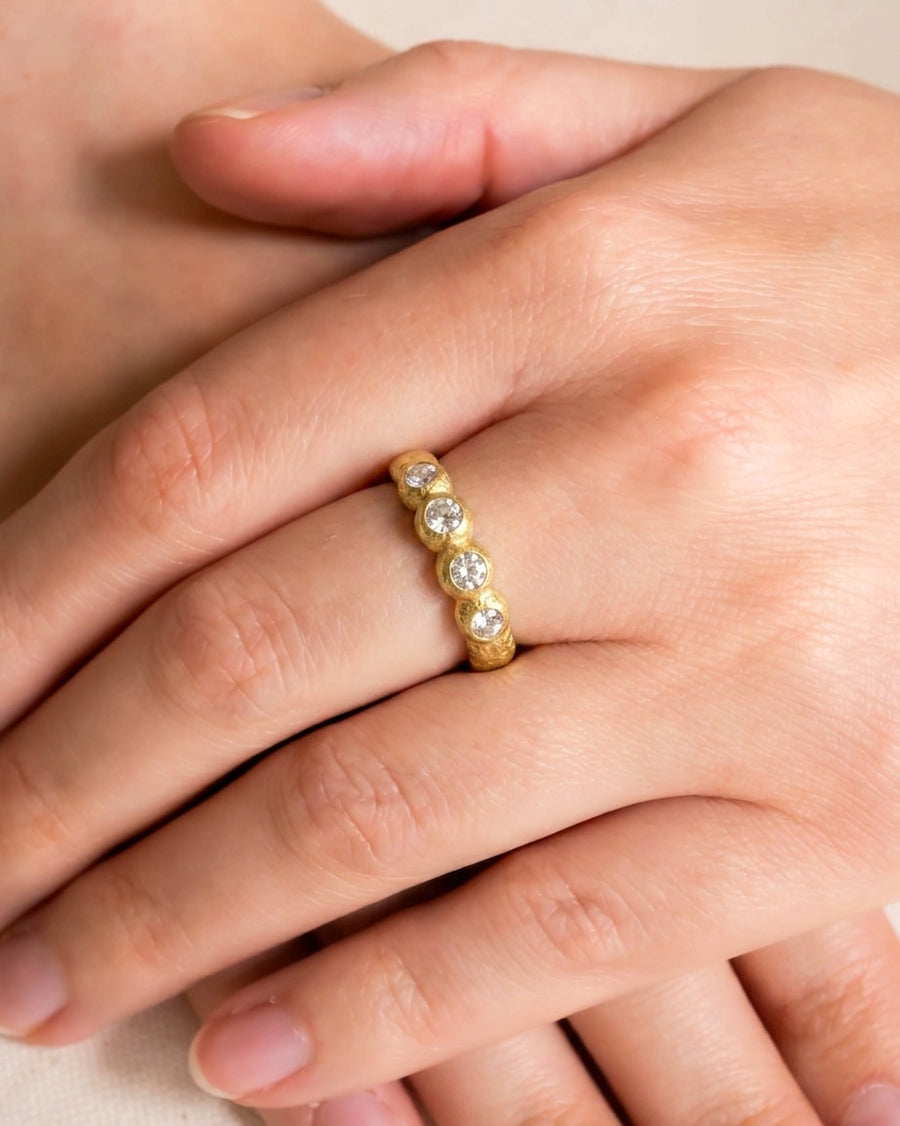 Gold nugget ring with four round diamonds.