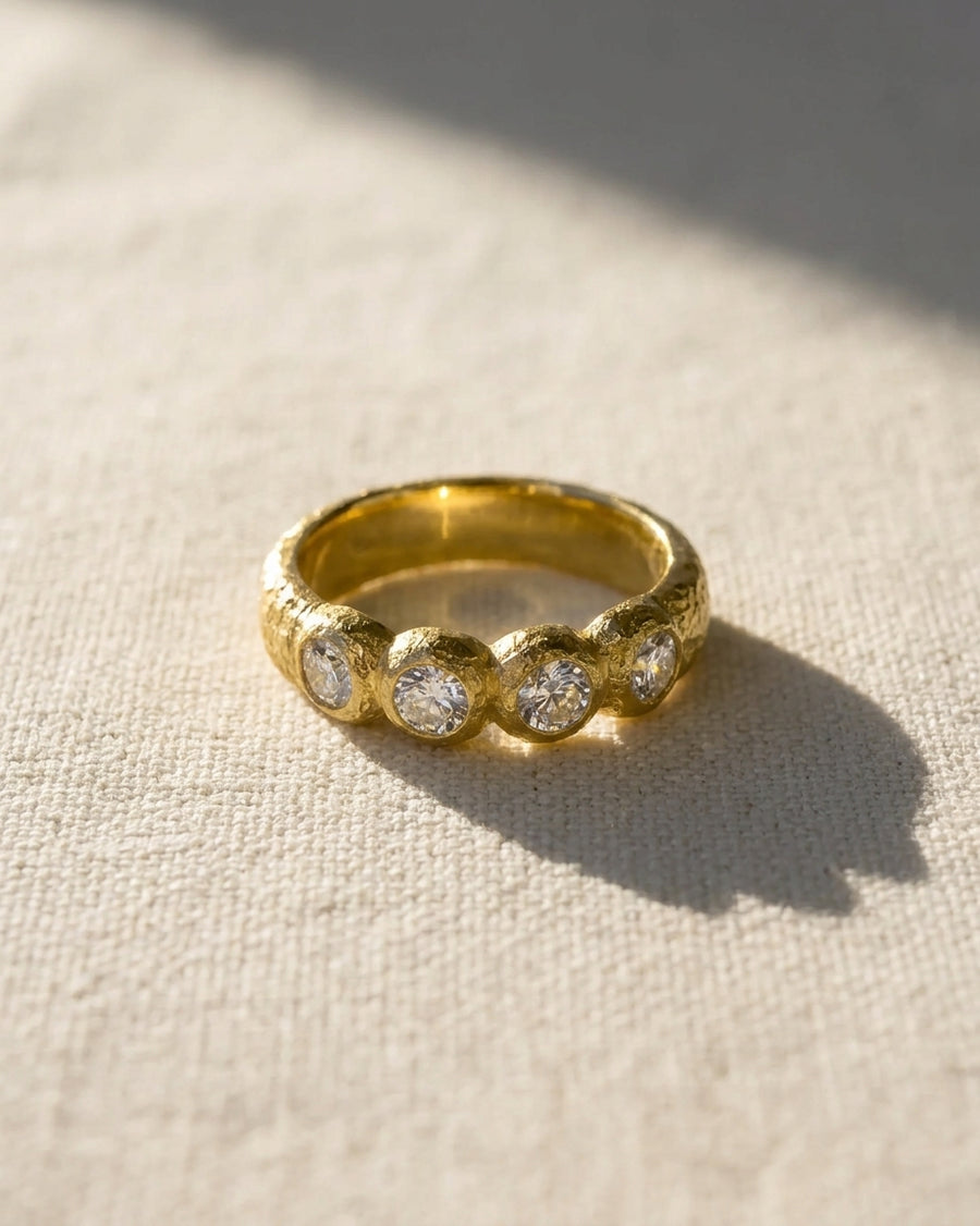 Gold nugget ring with four round diamonds.