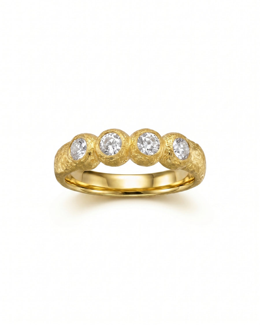 Gold nugget ring with four round diamonds.