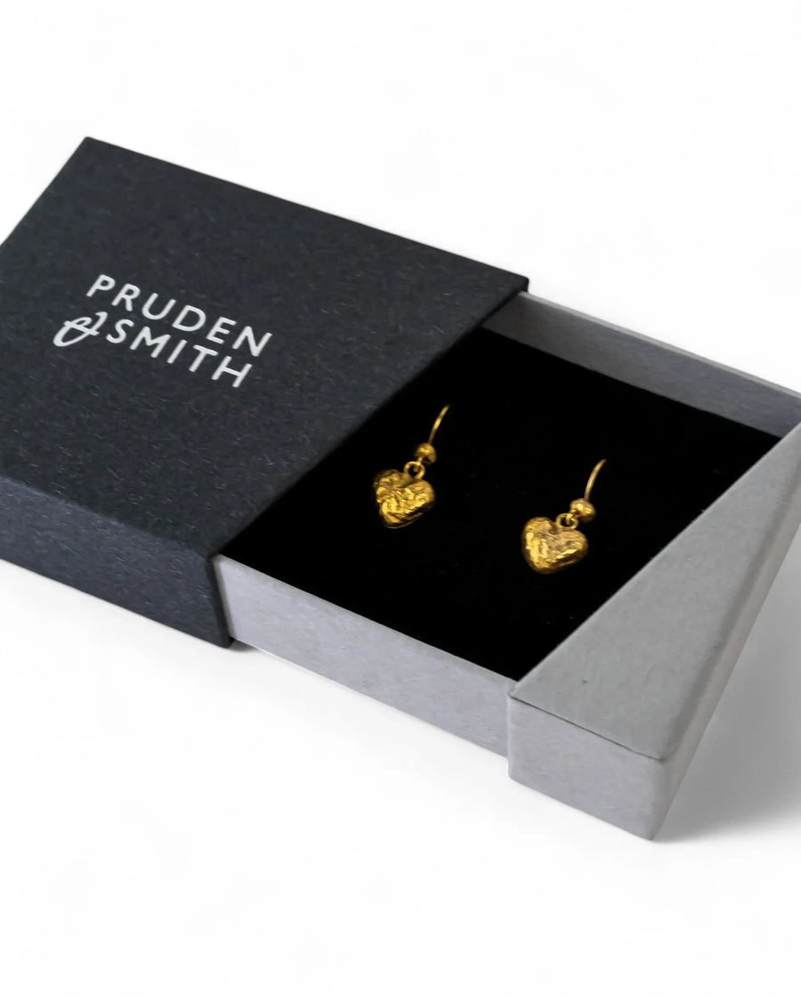 Gold nugget heart drop earrings in a black gift box.