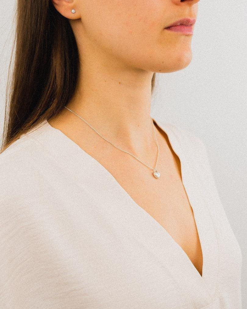 Silver chain with a small, textured nugget heart pendant.