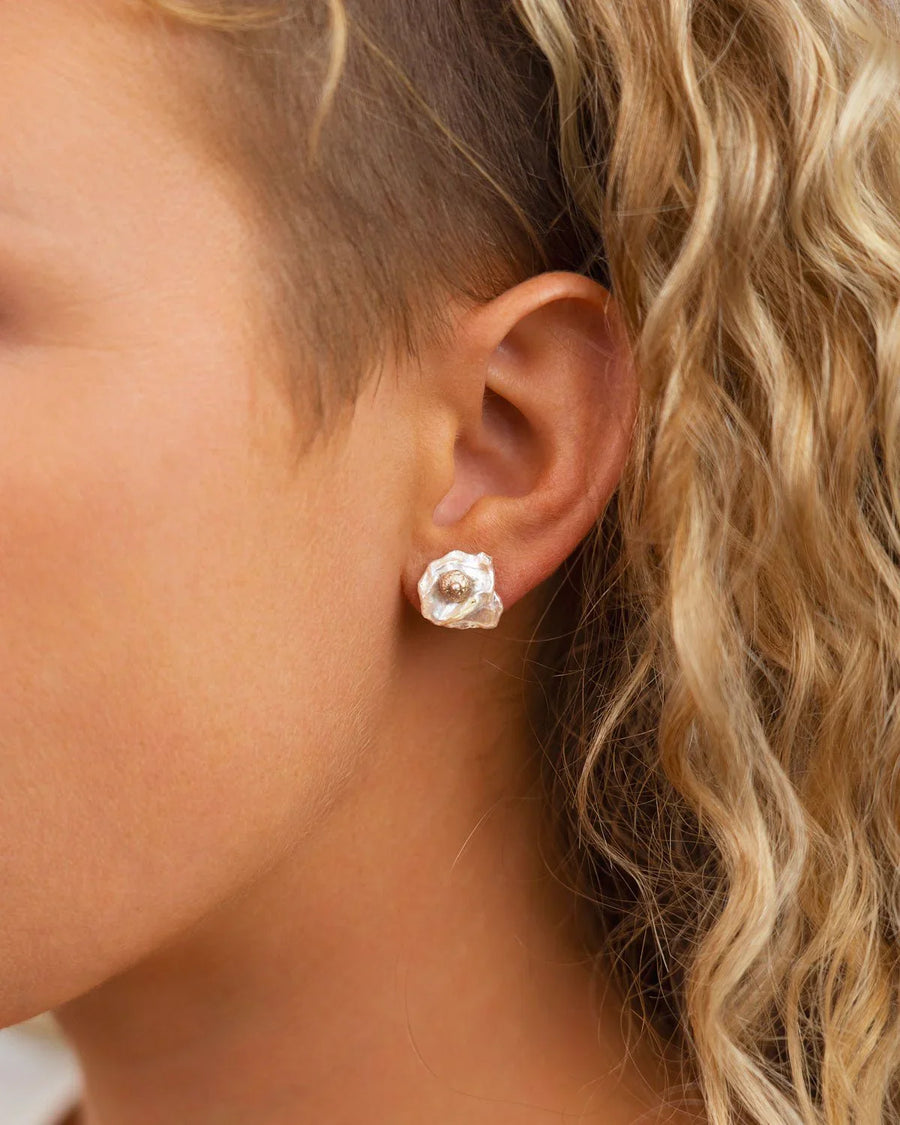 Silver nugget keshi pearl stud earring on an ear.