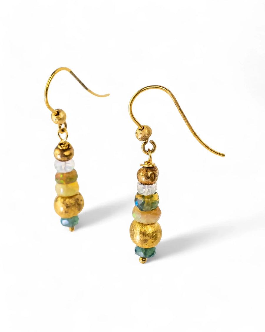 Gold dangly earrings with nugget opal beads and textured gold accents on a white background