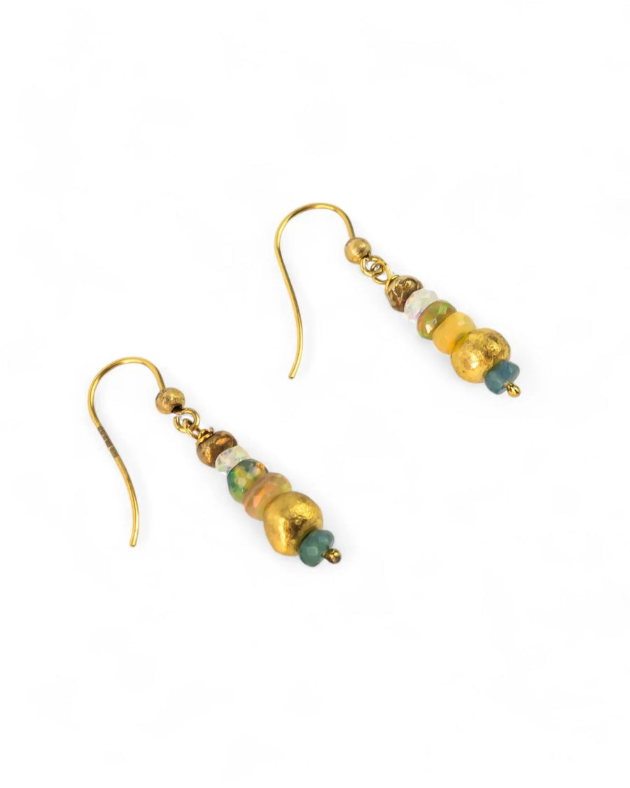 Dangly gold earrings with opal beads and rustic nugget accents on a white background