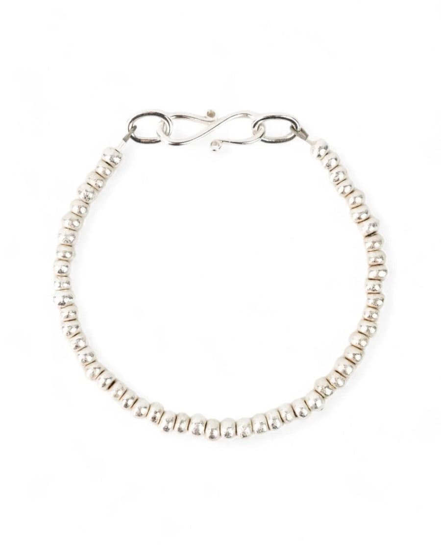 Handmade solid silver nugget bracelet with organic textured beads on white background