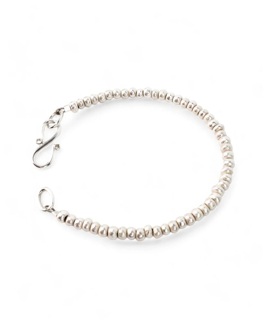 Handmade solid silver nugget bead bracelet with a simple clasp on white background