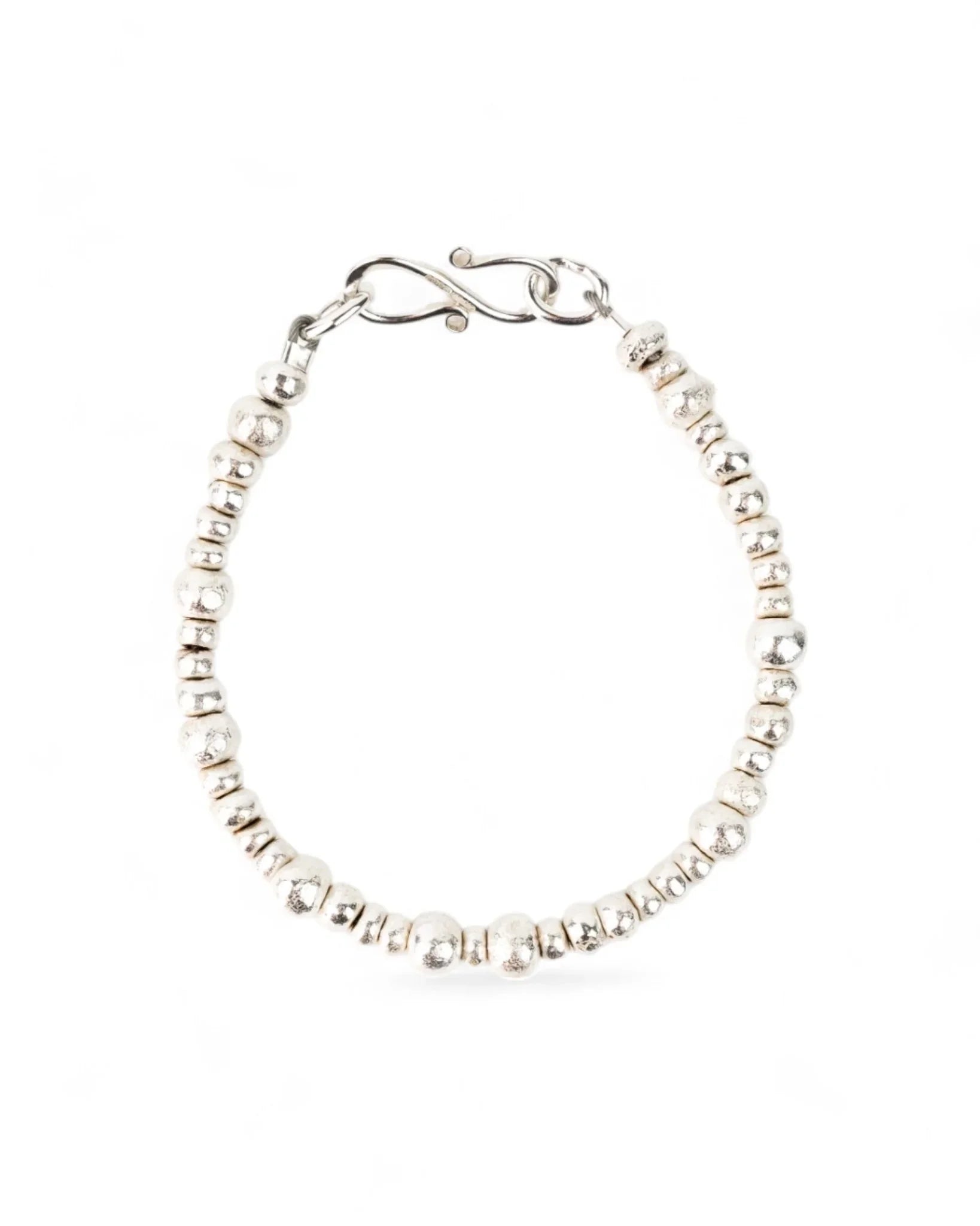 Handmade silver nugget bracelet with organic textured beads on a white background